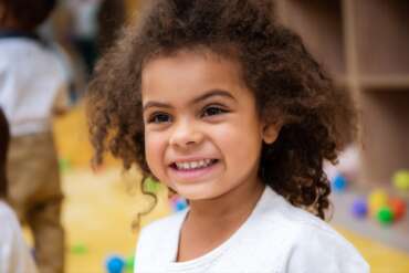 portrait of kid looking away in kindergarten