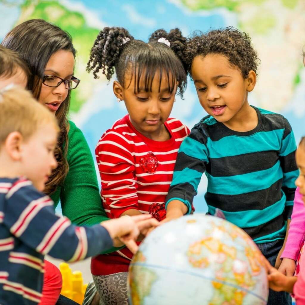kids looking at a globe