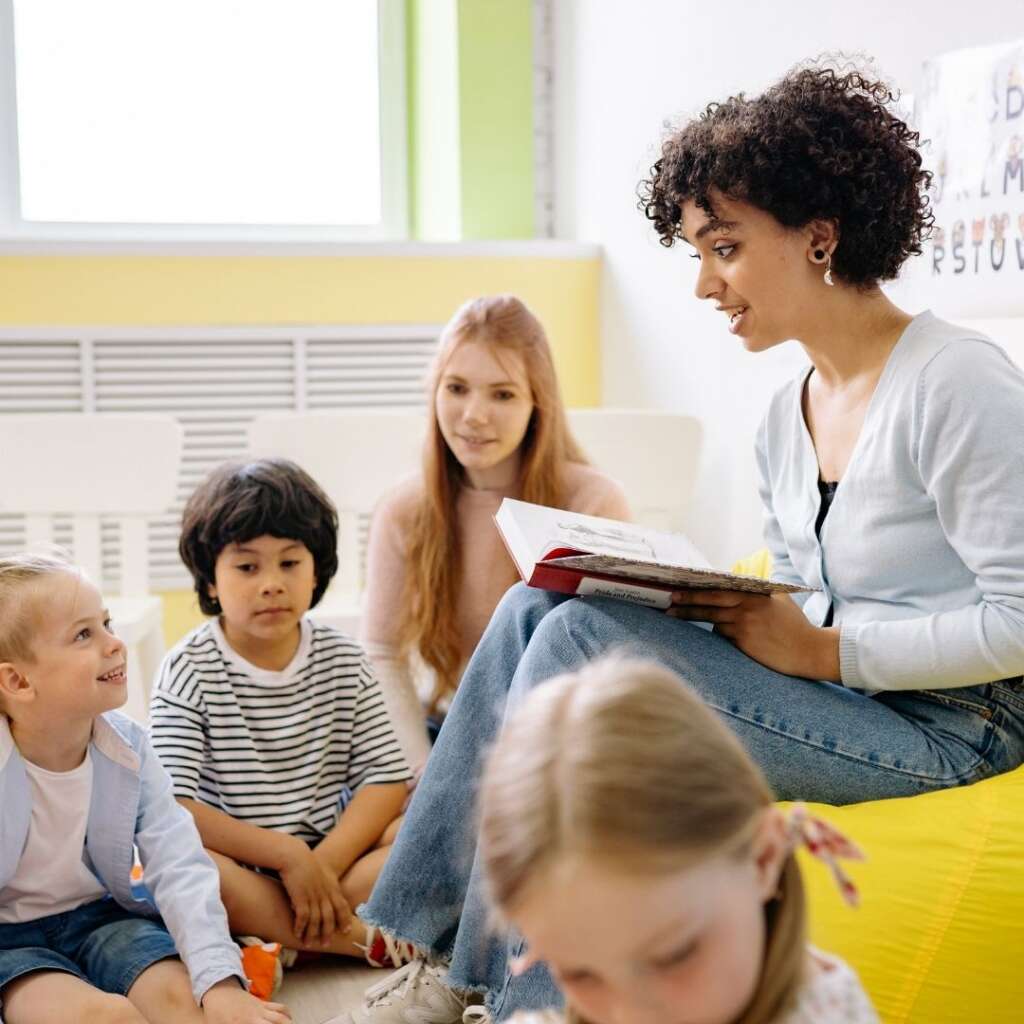 a teacher reading to kids