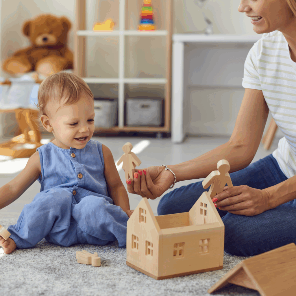 Little girl playing with a doll house