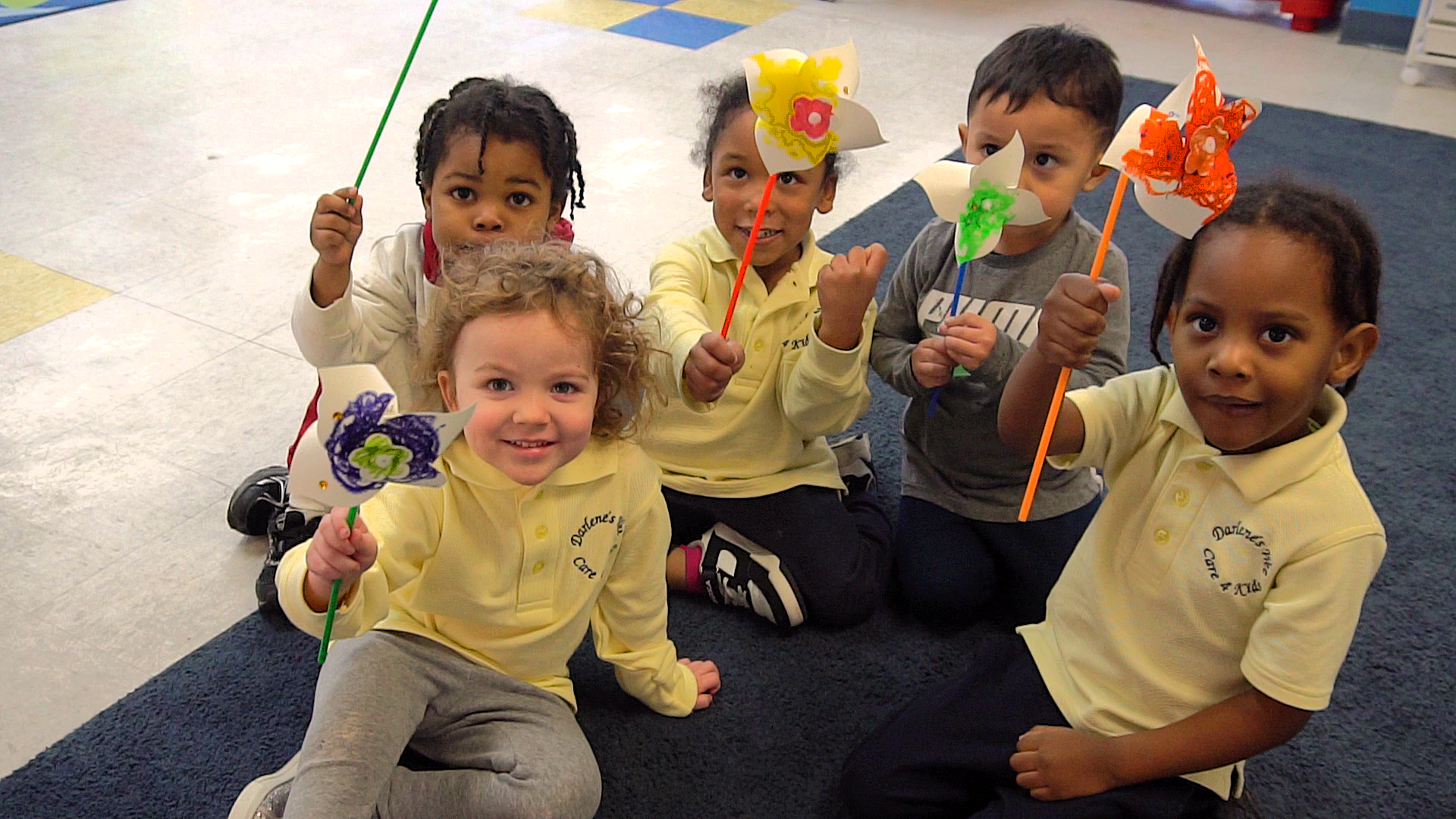 Children holding handmade pinwheels