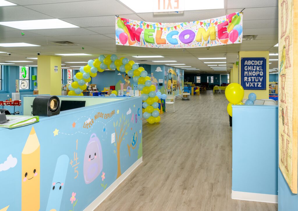 Colorful welcome area at Darlene’s Wee Care 4 Kids, with classroom murals and a welcome banner.